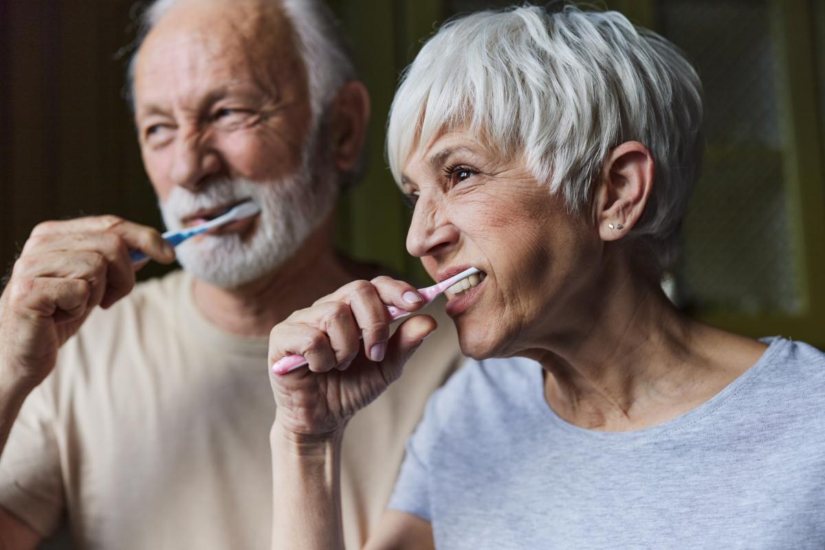 Senior couple brushing their teeth in the morning