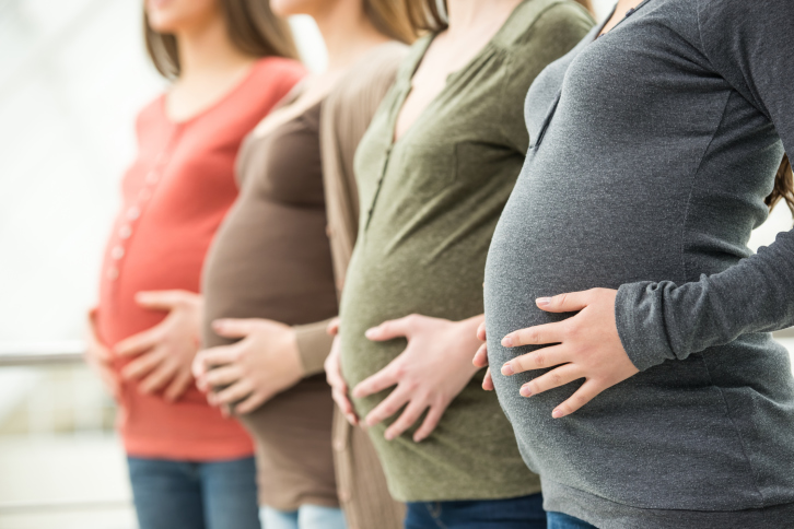 Pregnant women holding bellies