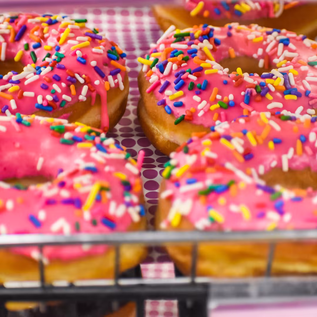 Pink donuts with sprinkles in a Supermarket