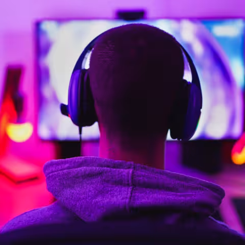 Young man wearing headset and play computer video games online