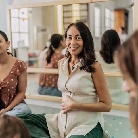 Portrait of a mid adult pregnant in a support group