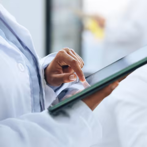 physician holding tablet reviewing information 