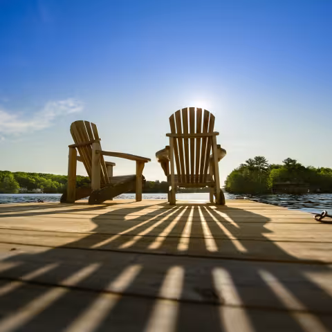 muskoka chairs on a dock long weekend