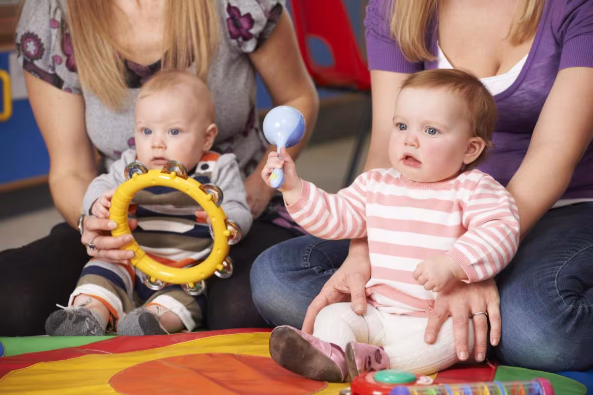 two babies playing with musical instruments