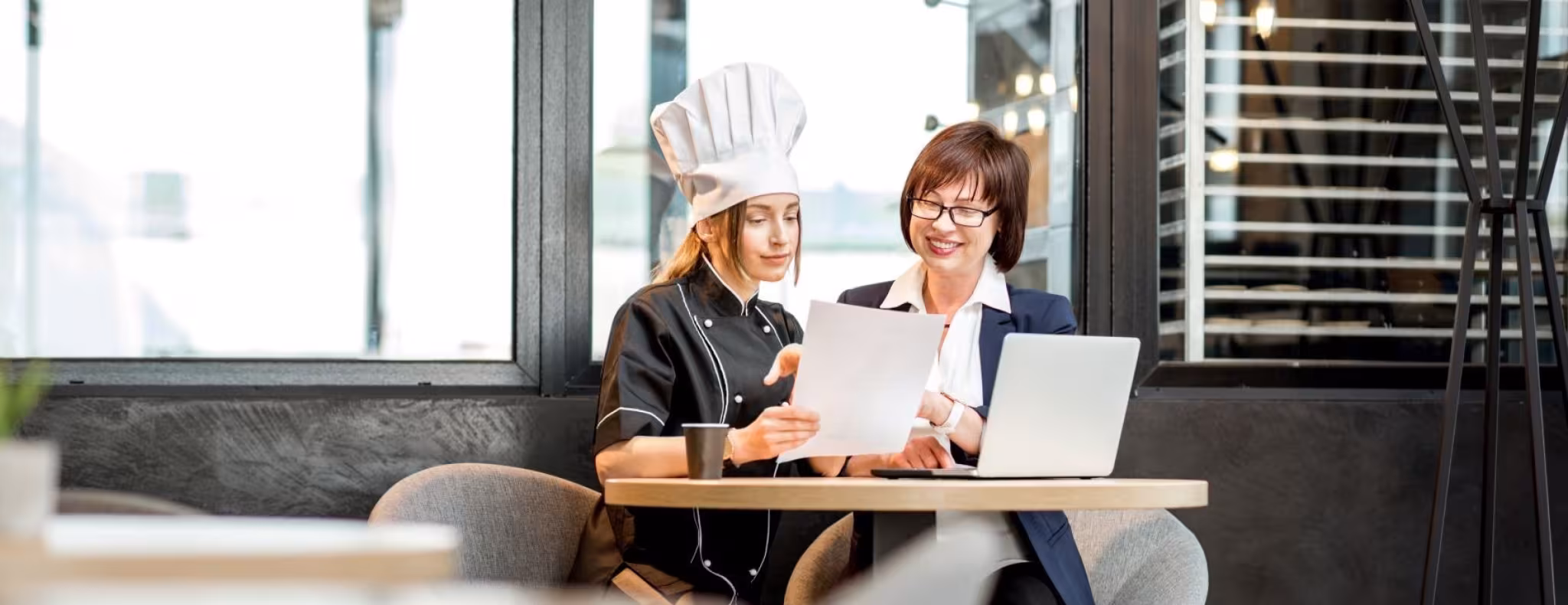 Two restauranteurs reviewing a menu together