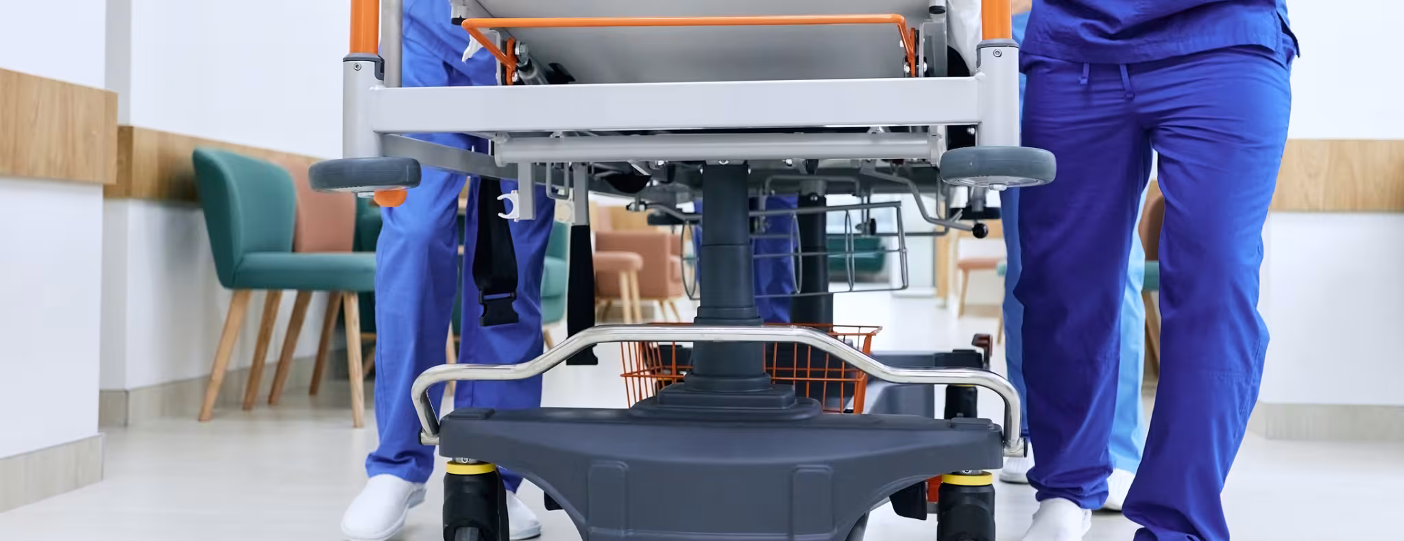 Medical staff pushing patient on medical gurney at emergency department, bottom view. 