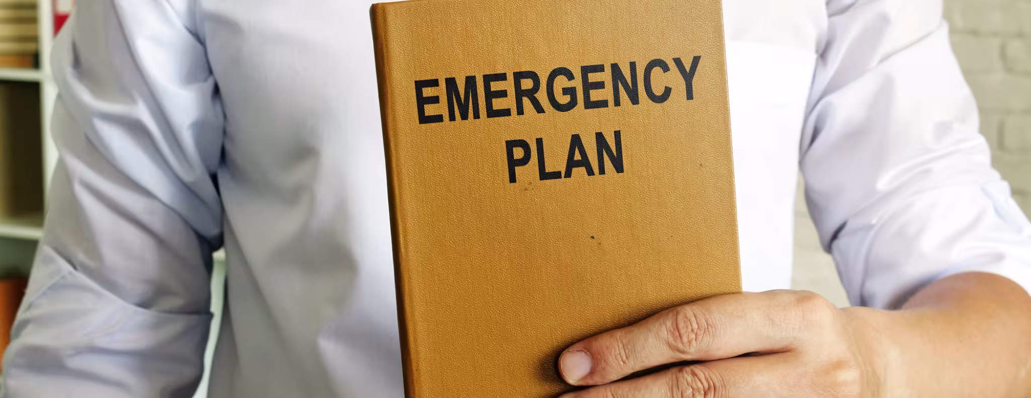 Man holding an emergency response plan for business.
