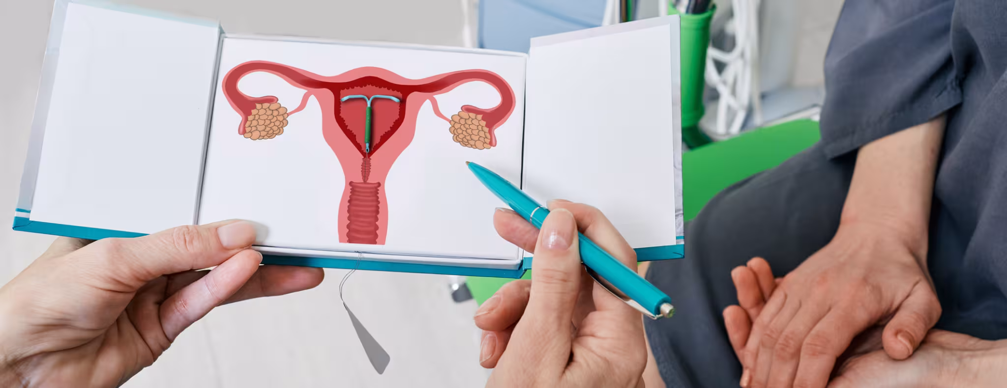 gynecologist showing female patient intrauterine contraceptive device or coil to prevent pregnancy while consultation
