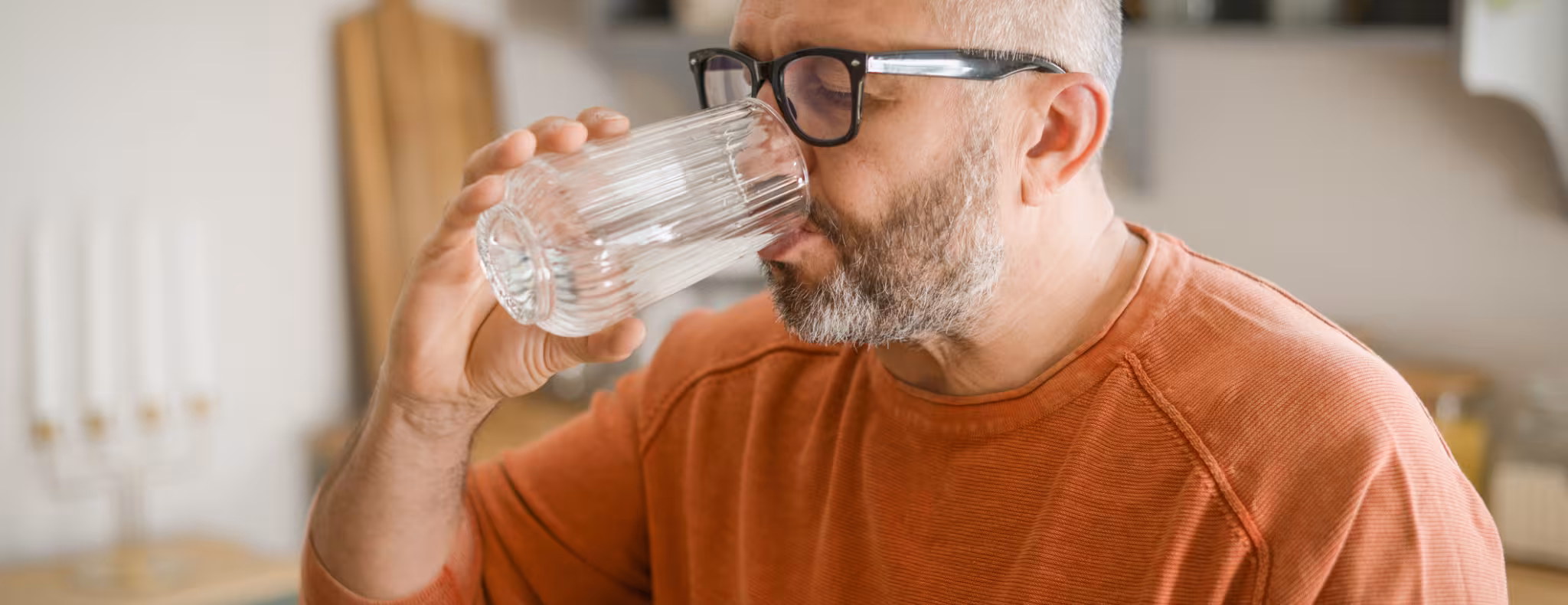 Mature adult man drinking water