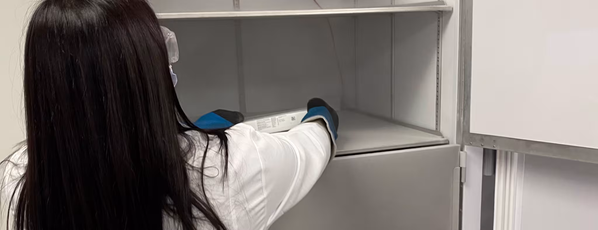 Nurse placing vaccines in fridge