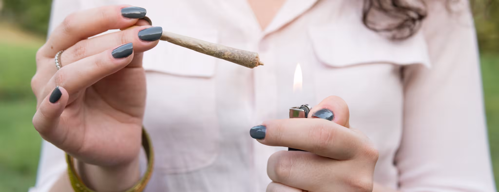 The young woman smoke cannabis blunt