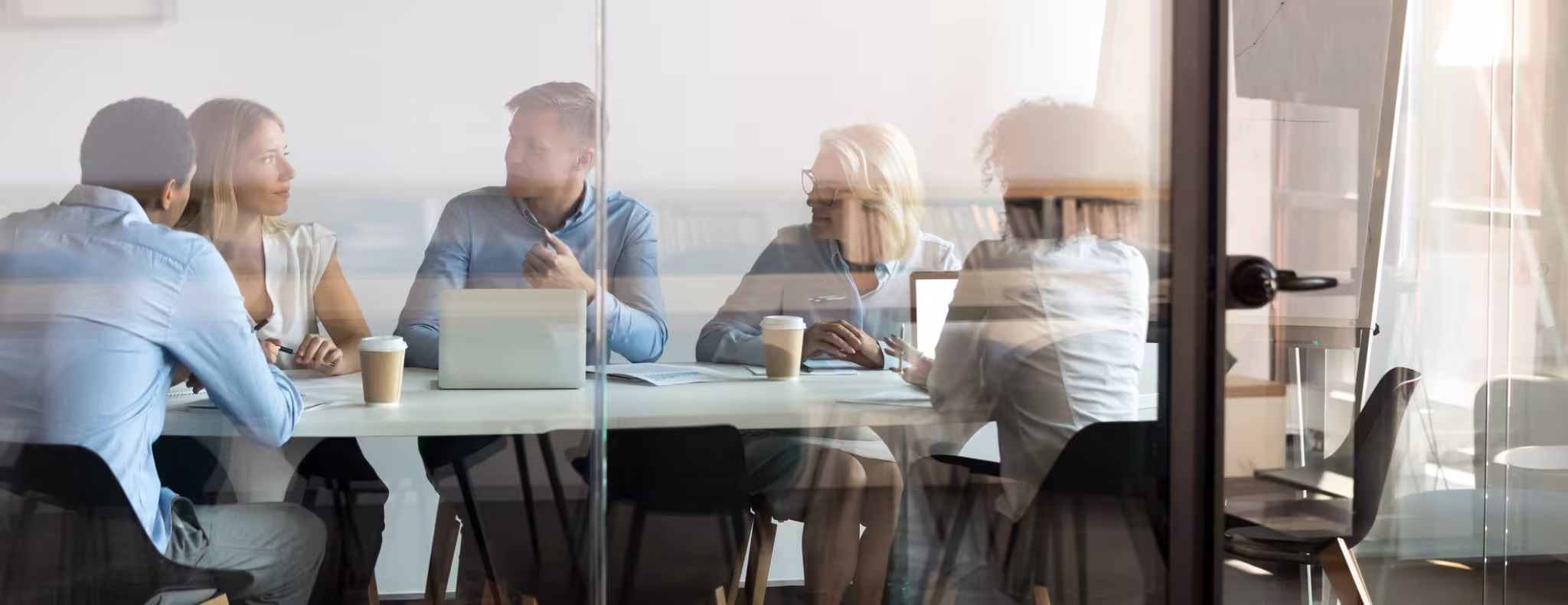 Business people sitting at boardroom behind closed doors