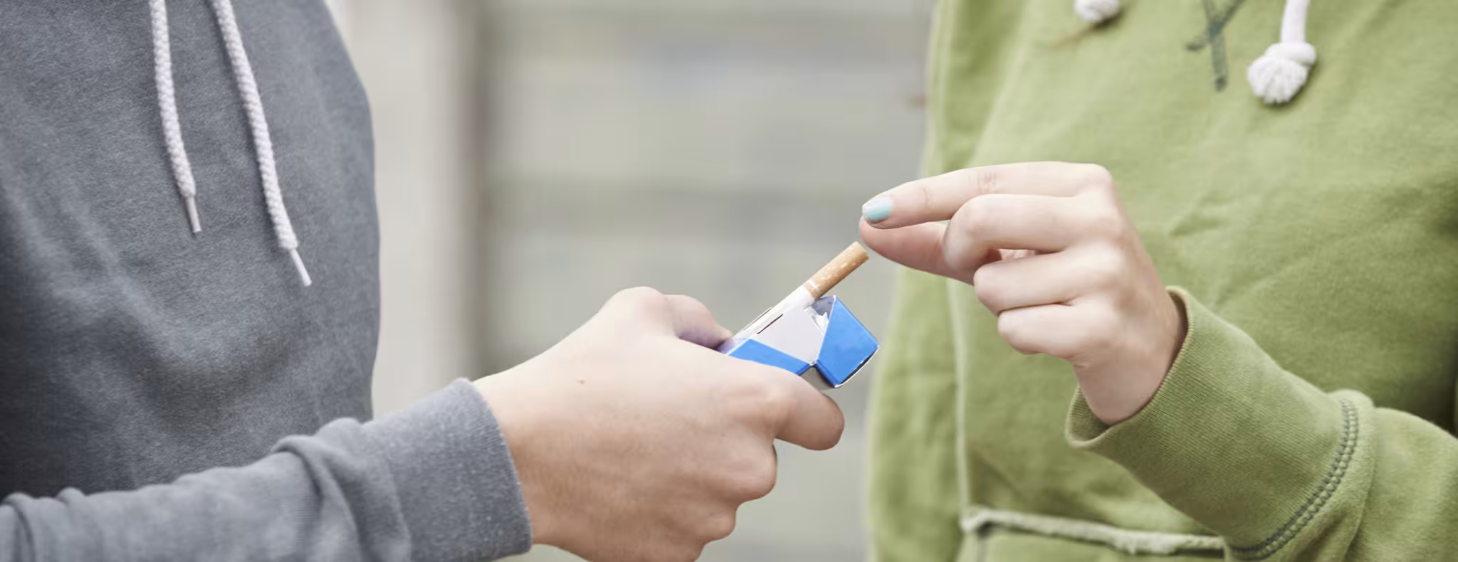 Close Up Of Teenager Boy Offering Girl Cigarette