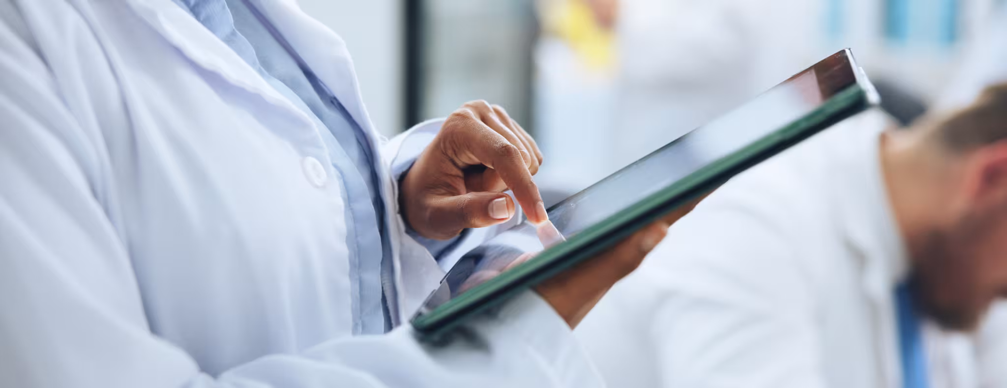physician holding tablet reviewing information 