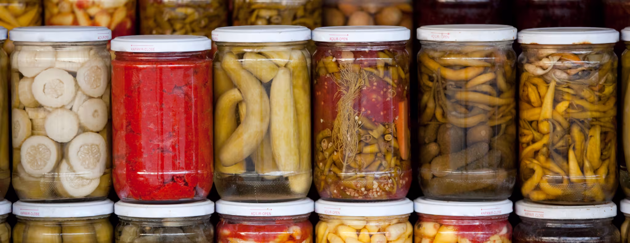 Assortment of glass jars filled with pickled vegetables 