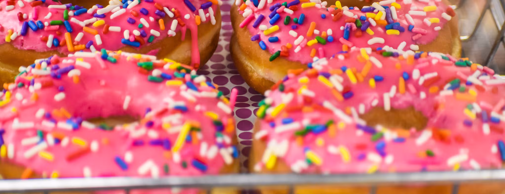 Pink donuts with sprinkles in a Supermarket