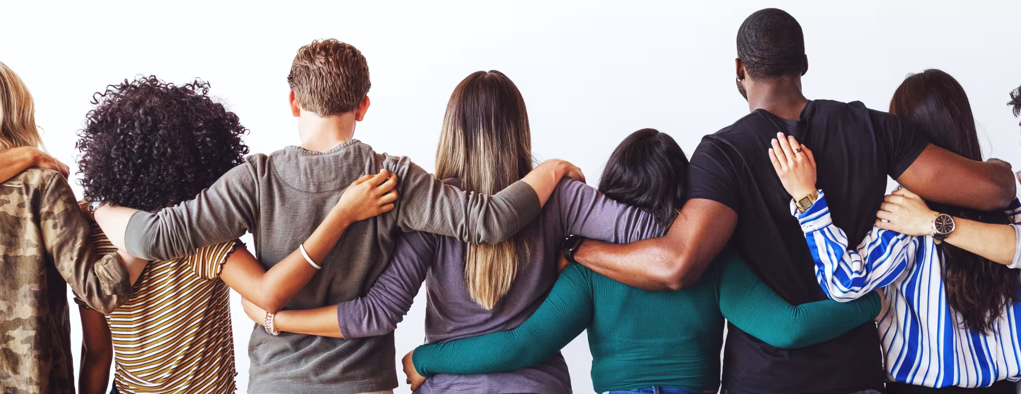 A diverse group of people standing together, arms linked.